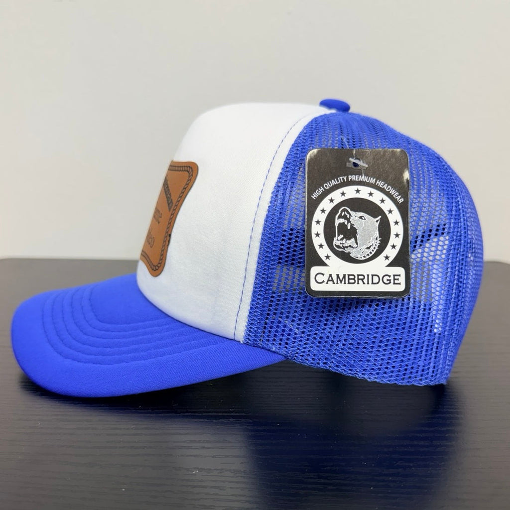 Cambridge royal blue mesh trucker cap, side view with manufacturer tag