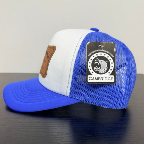 Cambridge royal blue mesh trucker cap, side view with manufacturer tag